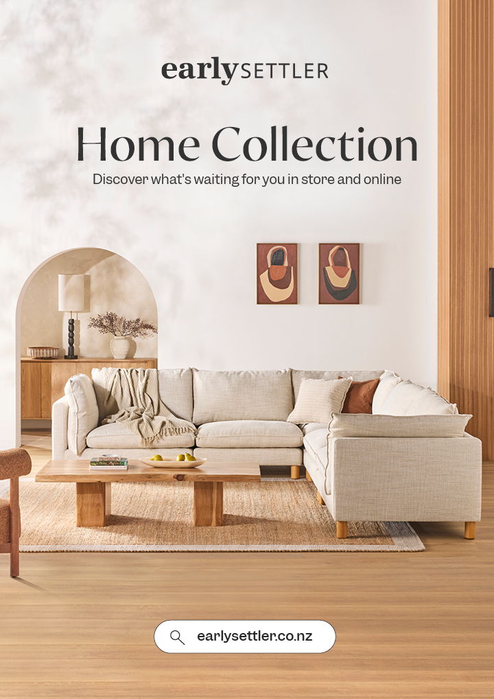 Living room showcasing a sofa, wooden furniture, and decorative wall art.