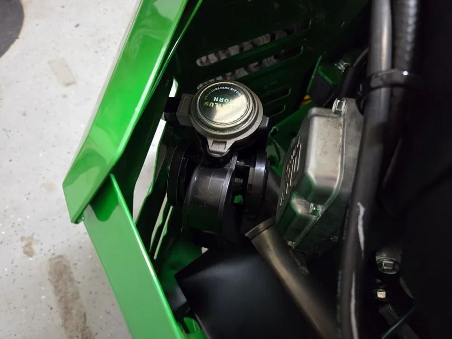 Black compact air horn installed green mower body panel silver cap wiring zip ties John's John Deere Z530R Compact Electric horn gallery photo 2