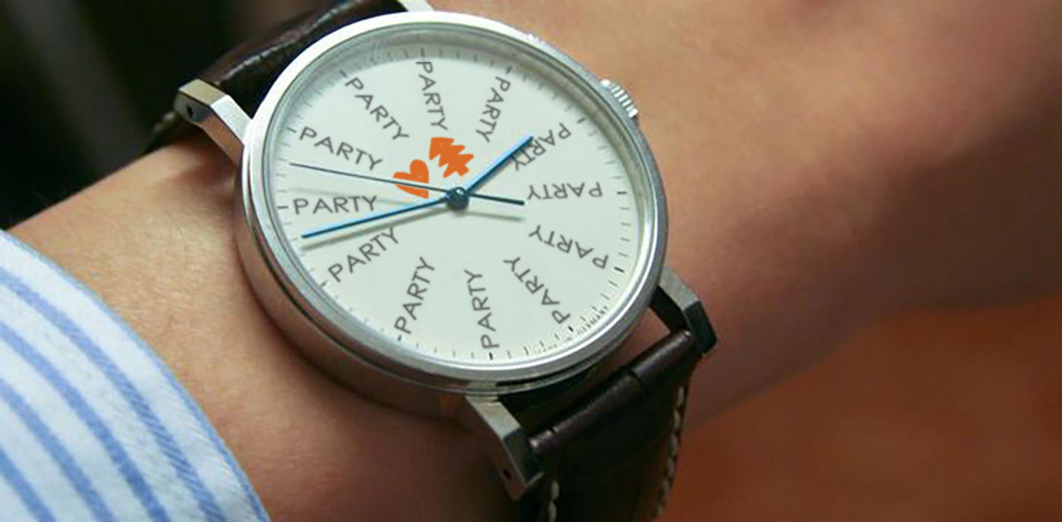 A wristwatch with colorful hands and playful hour markers.