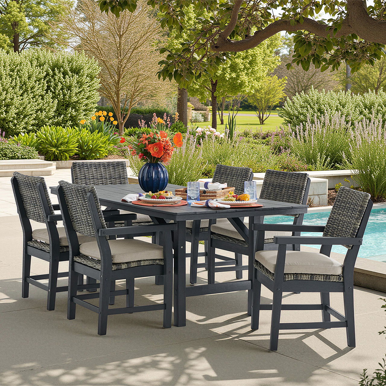 Outdoor dining table with chairs, flowers, and a pool in the background.