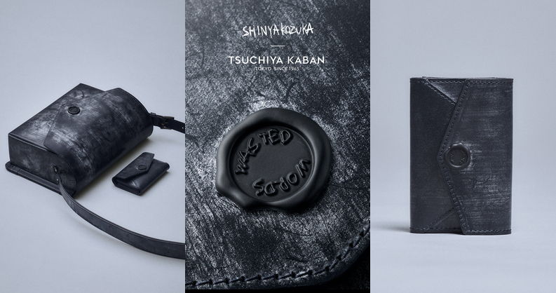 Black textured bag and notebook with circular logo on a light background.