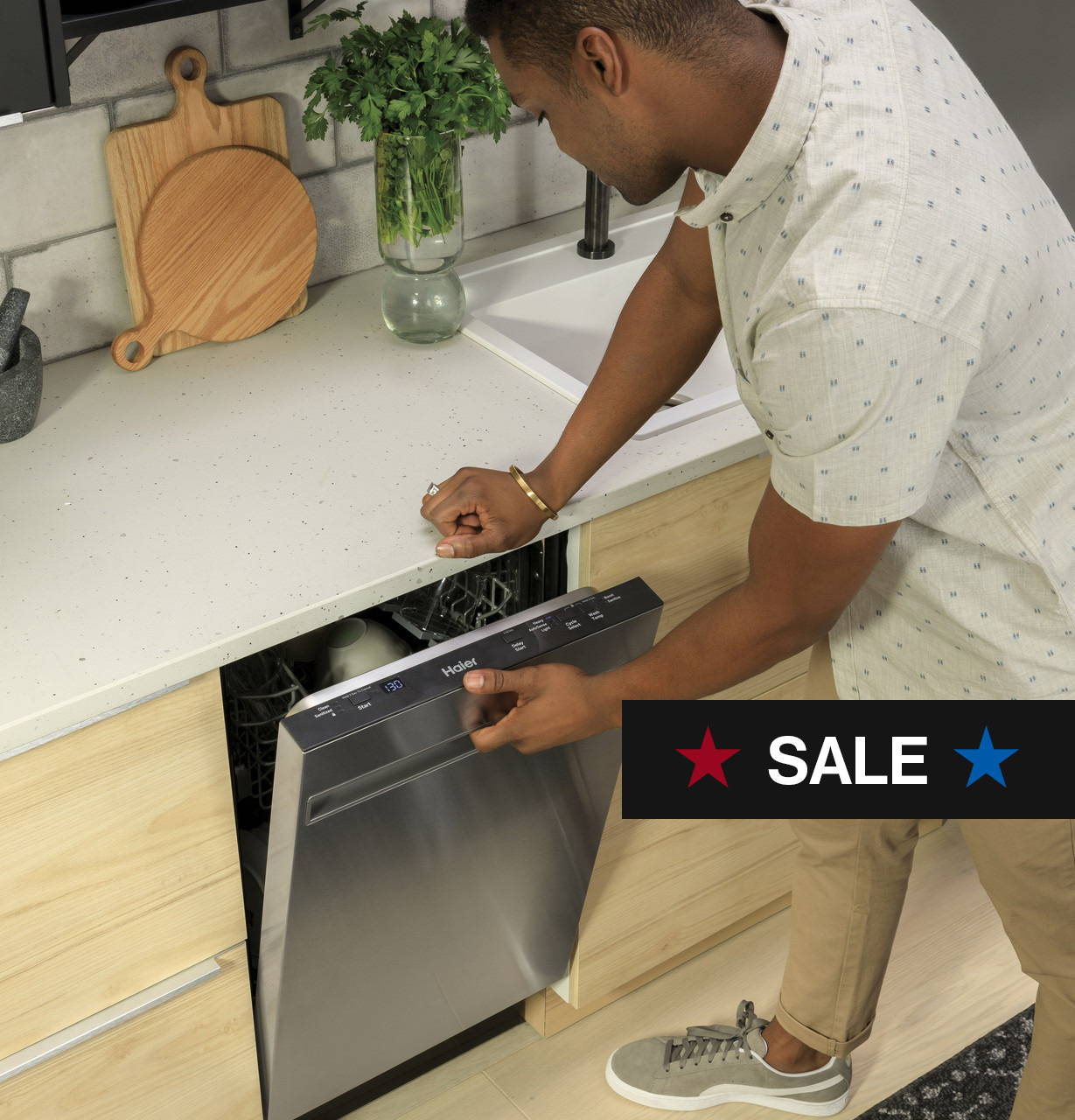 Young black man opening a Haier ENERGY STAR® 18