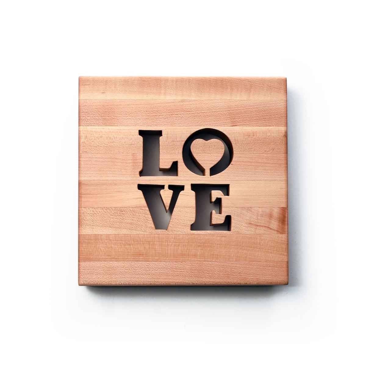 Wooden Trivet with the word love engraved in it