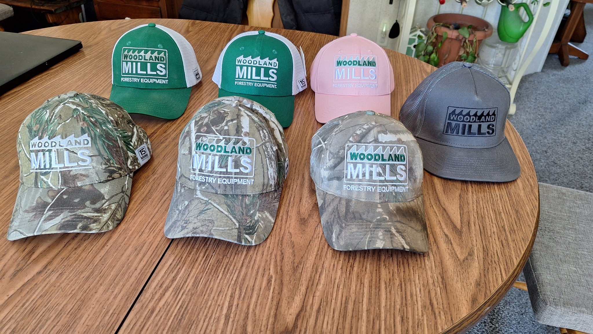 Various hats displayed on a wooden table.