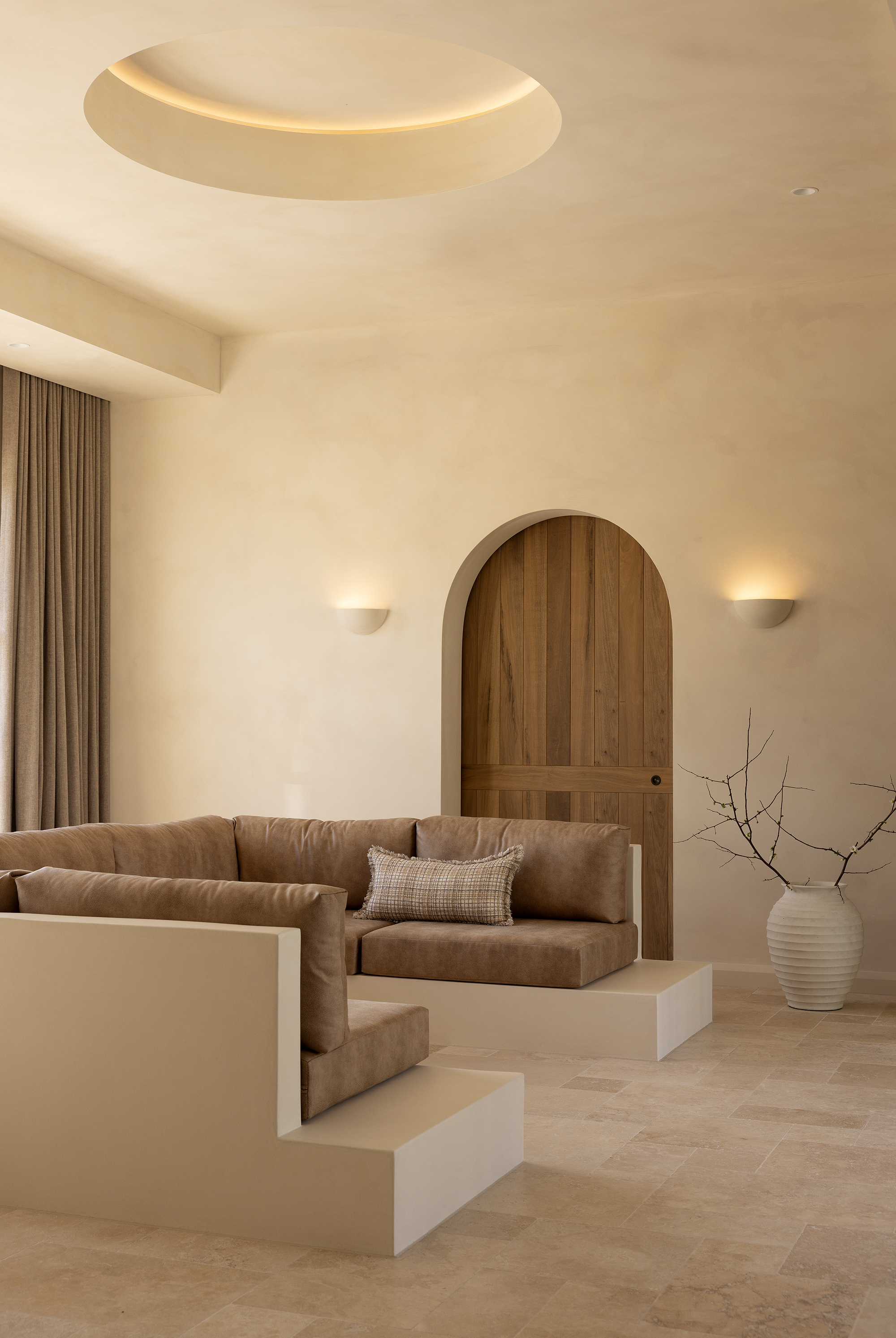 Modern living room with neutral tones and minimalist wall lights