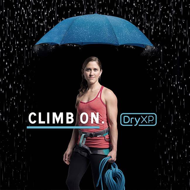 image of Women climber standing under an umbrella