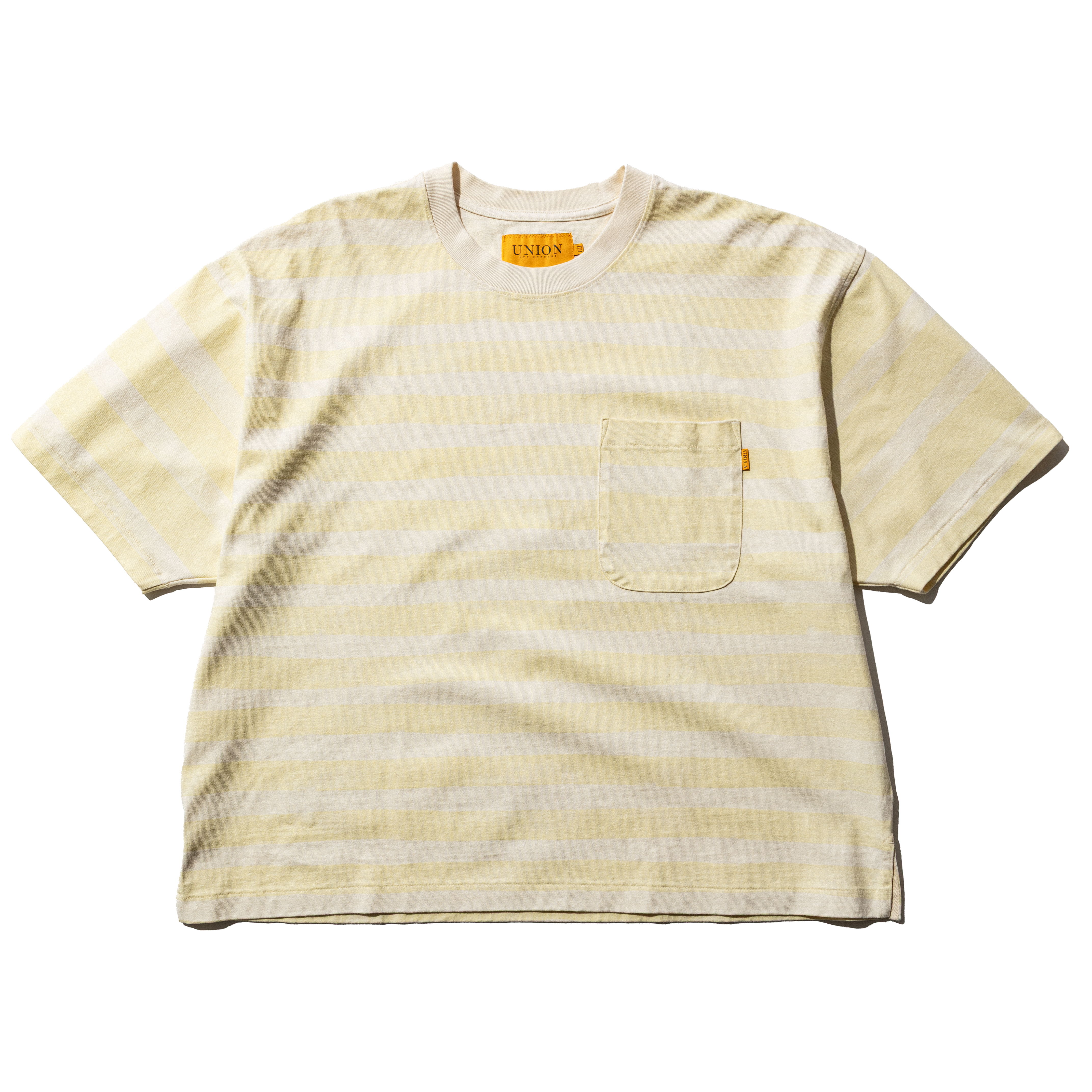 Striped yellow t-shirt with a pocket and orange label on the neckline.