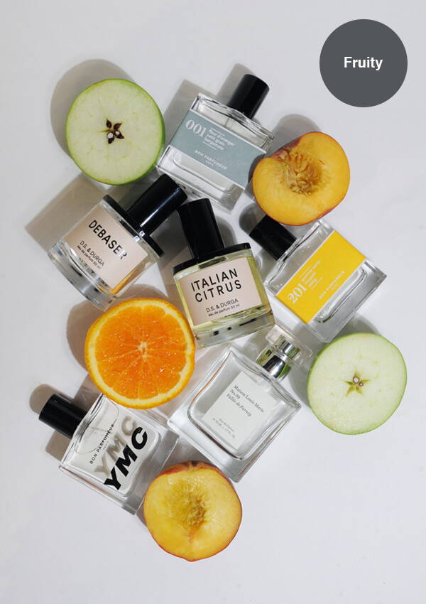 A styled flat lay image of multiple fruity fragrances by D.S. & Durga, Maison Louis Marie and Bon Parfumeur amongst fresh summer fruits.