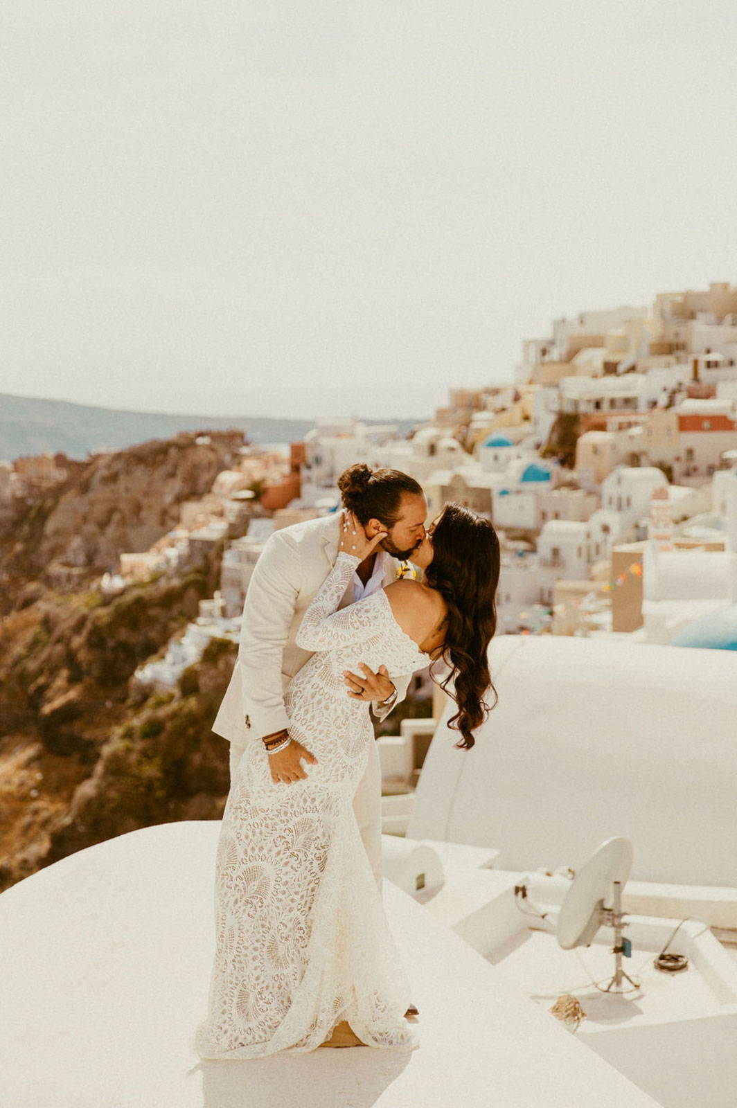 Bride and Groom kissing on hill line