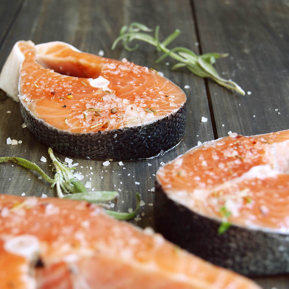 High Quality Organics Express Kosher Salt on Raw Salmon Filets