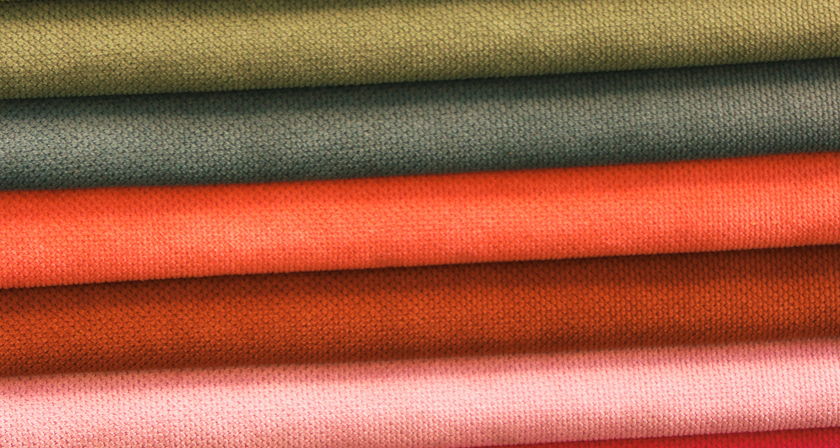 Upholstery fabric swatches in warm colors including terracotta, olive green, and dusty rose.