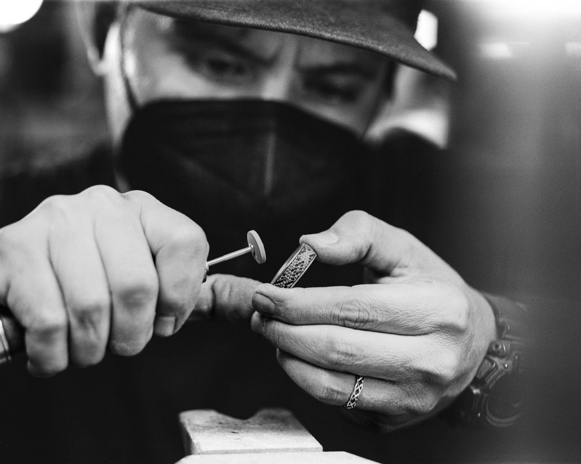 A NightRider jeweler handcrafting a Serpent Band