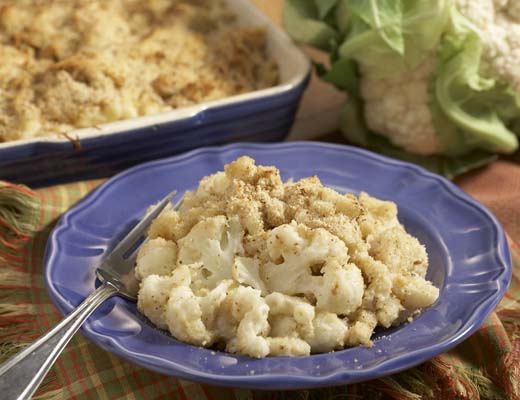 Baked cauliflower dish served on a blue plate with a fork.