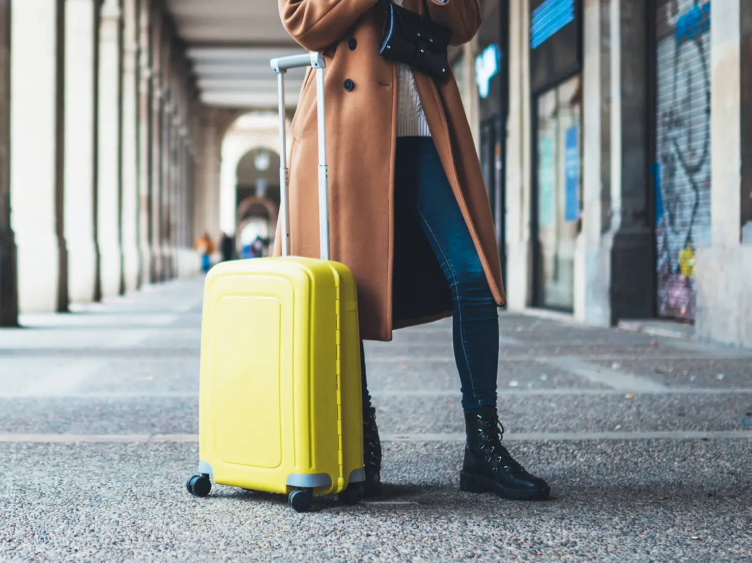 Woman standing with luggage while travling