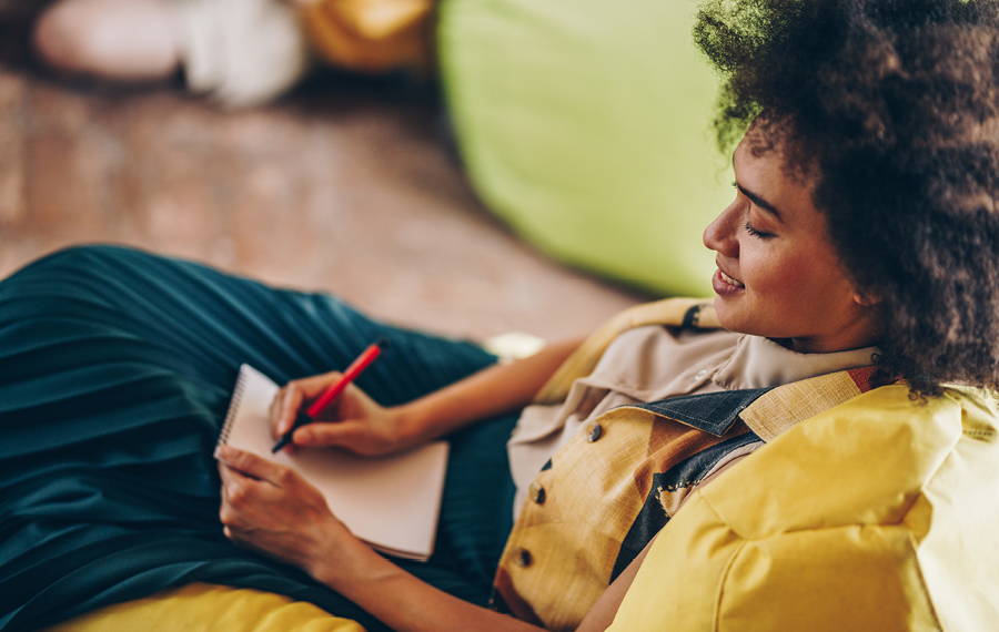 woman writing on note pad