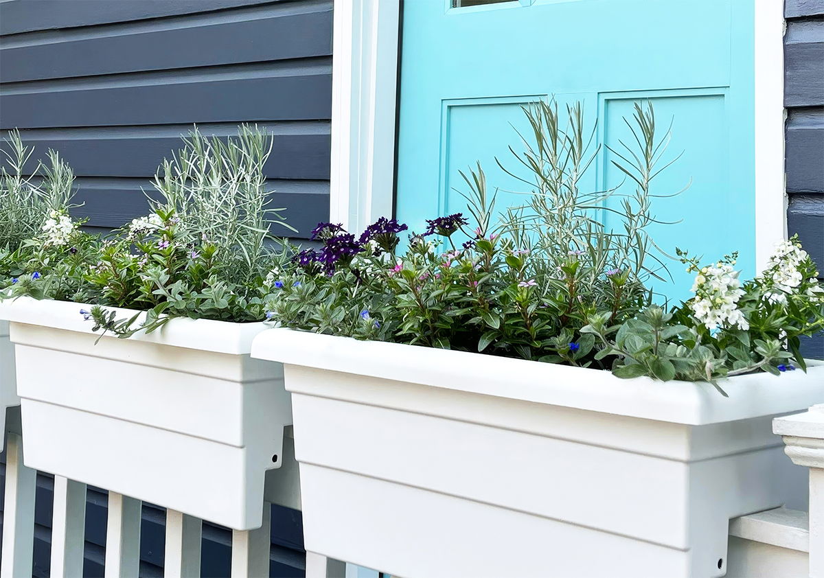 24-inch white railing planters growing various flowers