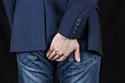 A picture of a man scratching his butt