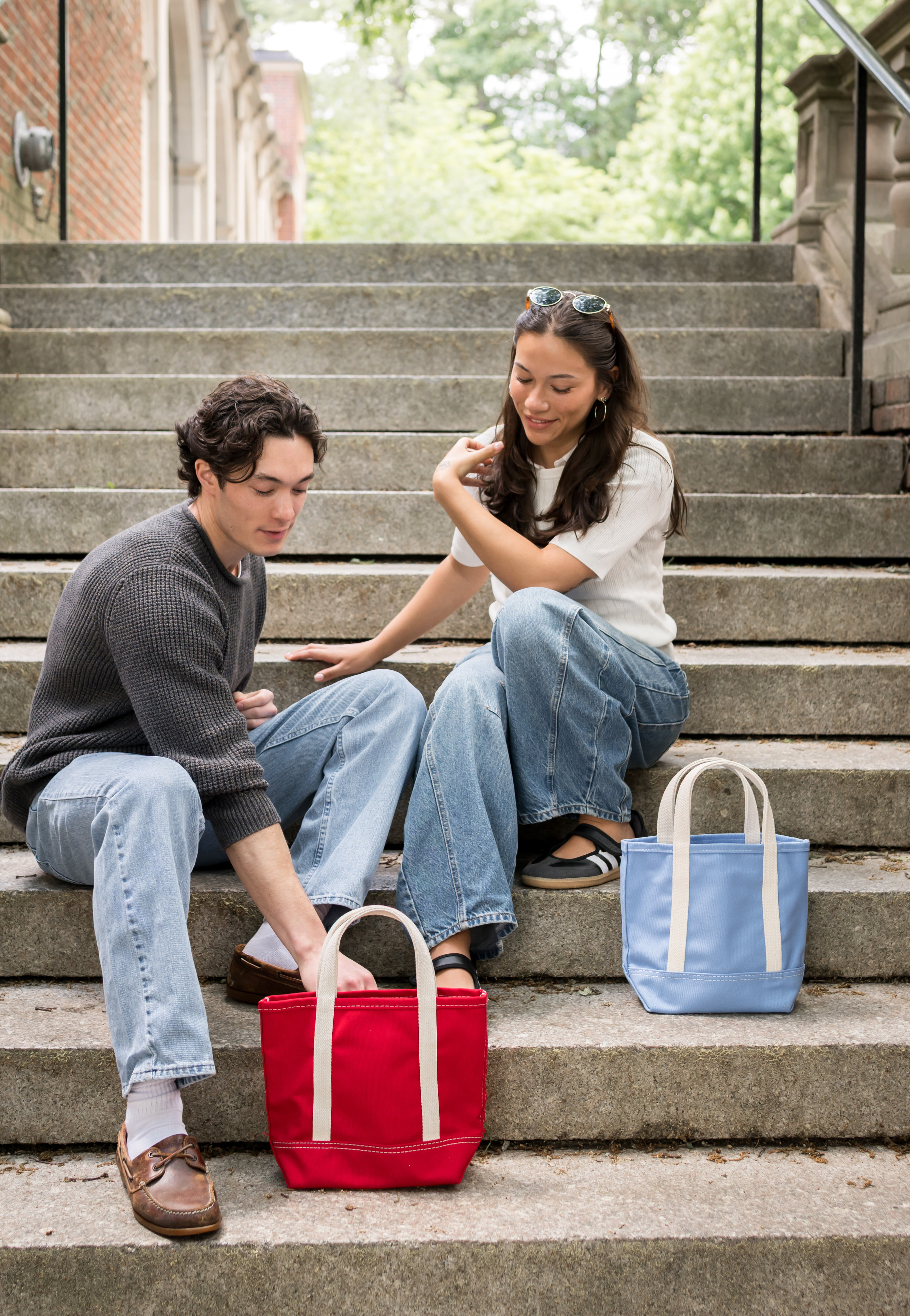 Students unpacking storage bins on dorm steps