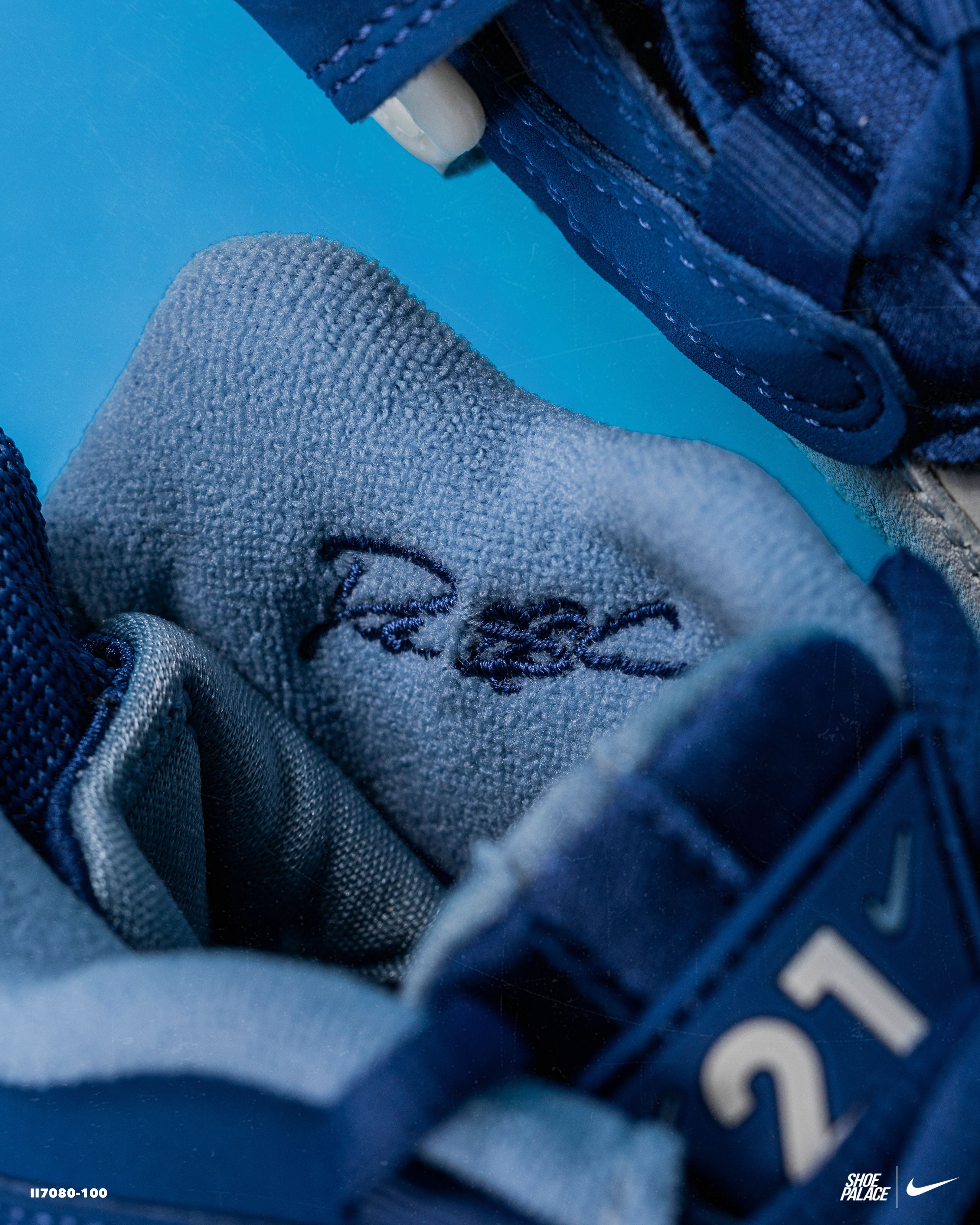 Close-up of a shoe interior showing a signature and number 21.