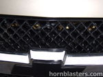 Close-up brass air lines and fittings mounted behind Joe's Silverado grille photo 3