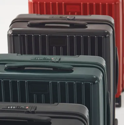 Four suitcases in different colors lined up.