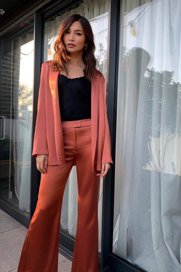 Gemma Chan wears Galvan London Wide Leg Satin Orange Trouser