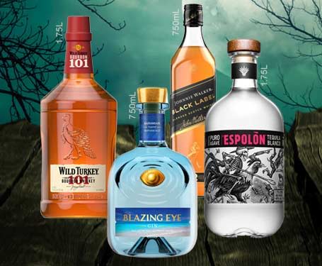 Four bottles of various alcoholic beverages against a dark, moody background.
