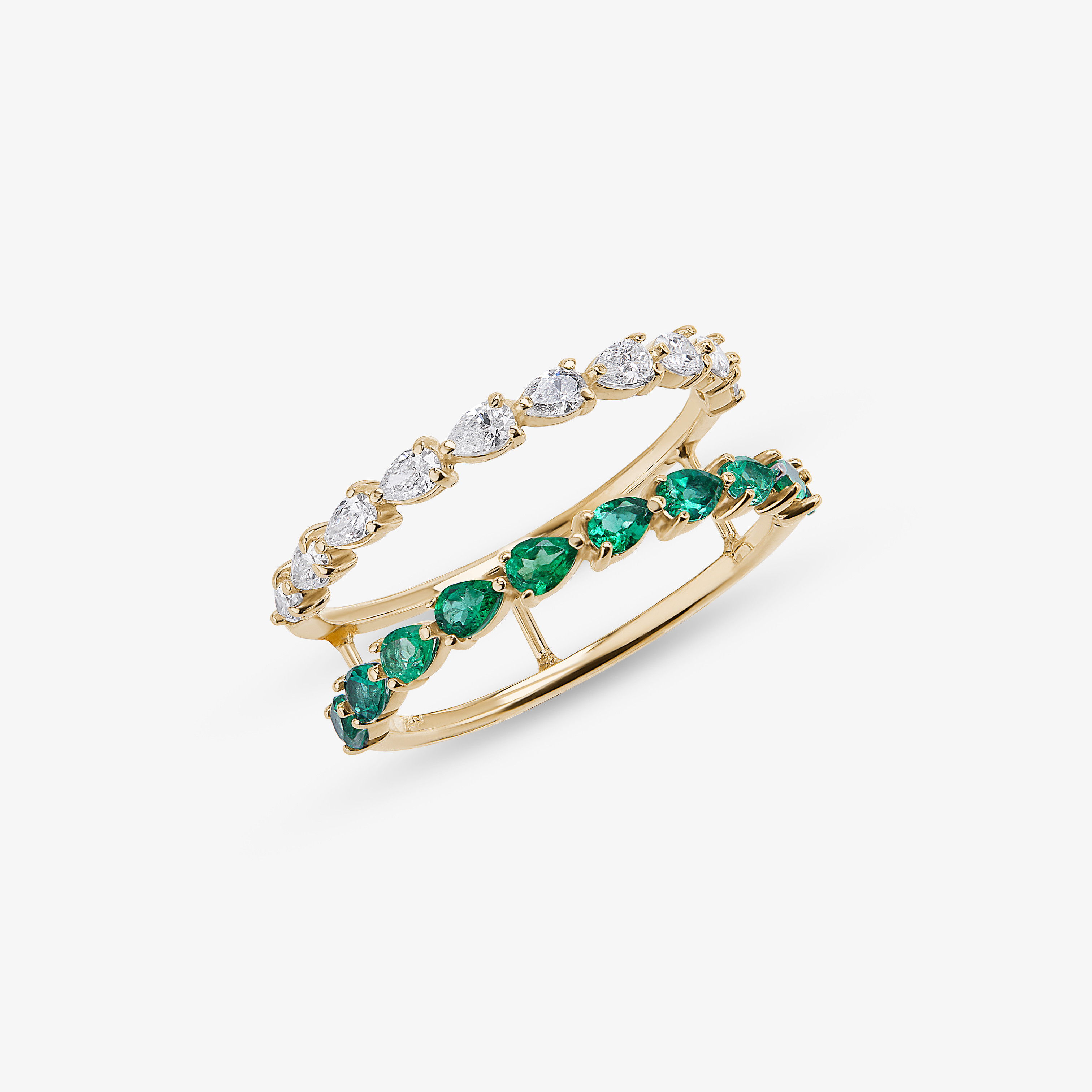 Stacked yellow gold rings featuring alternating round diamonds and emerald gemstones in a delicate band design.