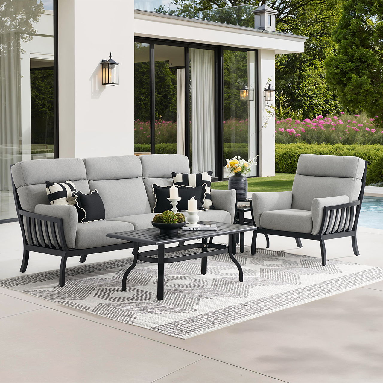 Outdoor seating area with gray furniture and a coffee table.