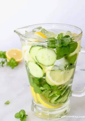 Big jug of water with lemons, cucumber and mint leaves