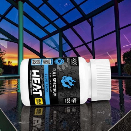 Bottle of HEAT supplement with sunset view in background.