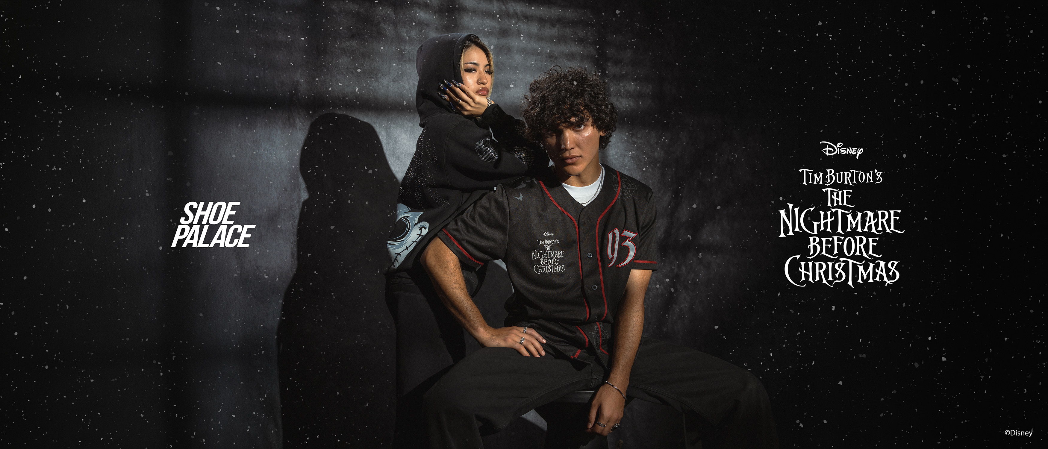 Two people posing together against a dark background, promoting a Disney project.