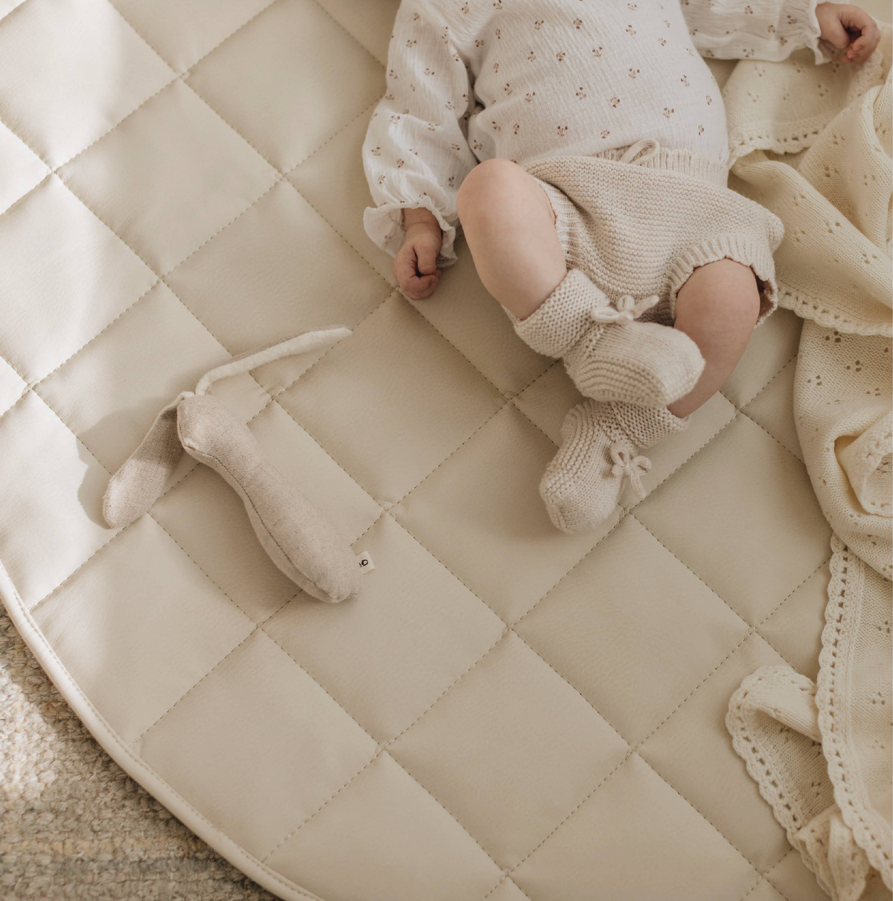 Baby laying on Quilted Mini Mat