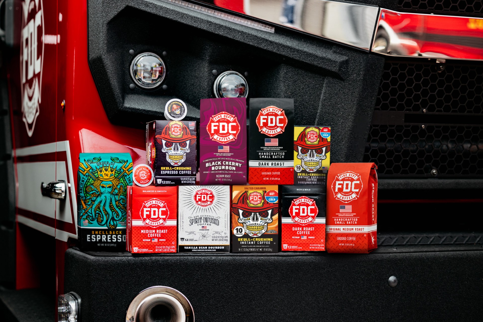 Assorted coffee bags displayed on a fire truck's side.