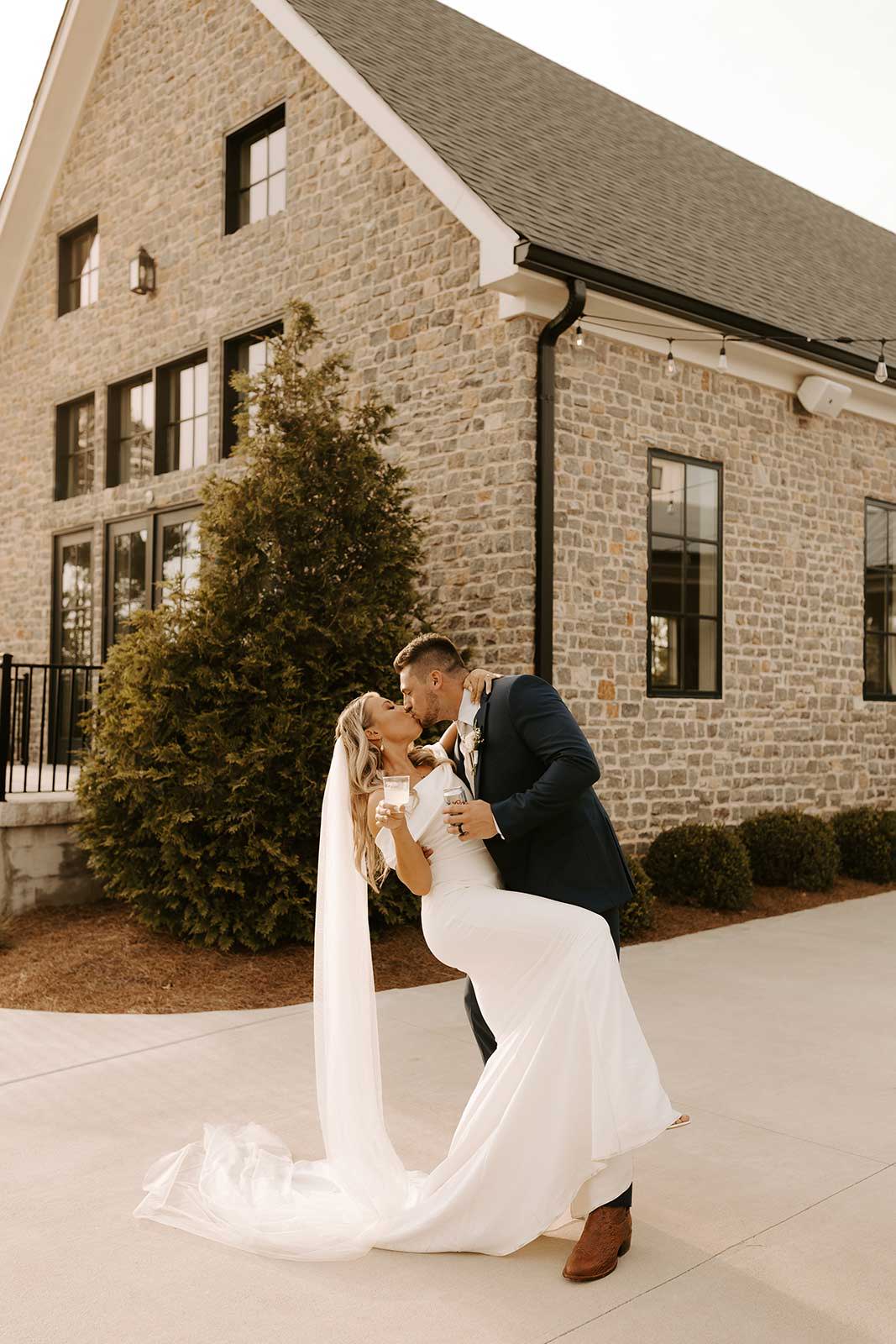 Bride and groom sharing a kiss outside the wedding chapel