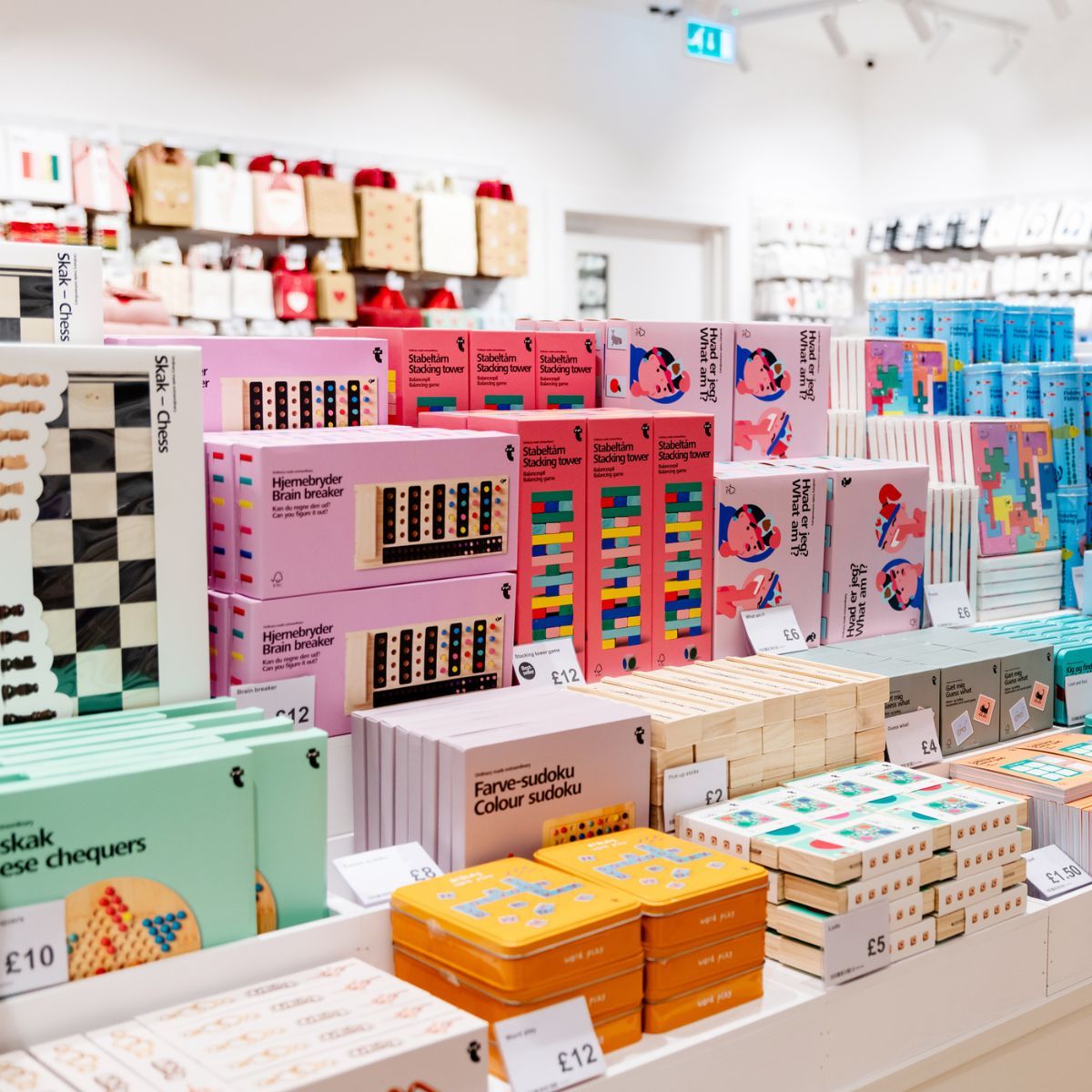 Colorful shelves filled with various games and toys at flying tiger copenhagen store.