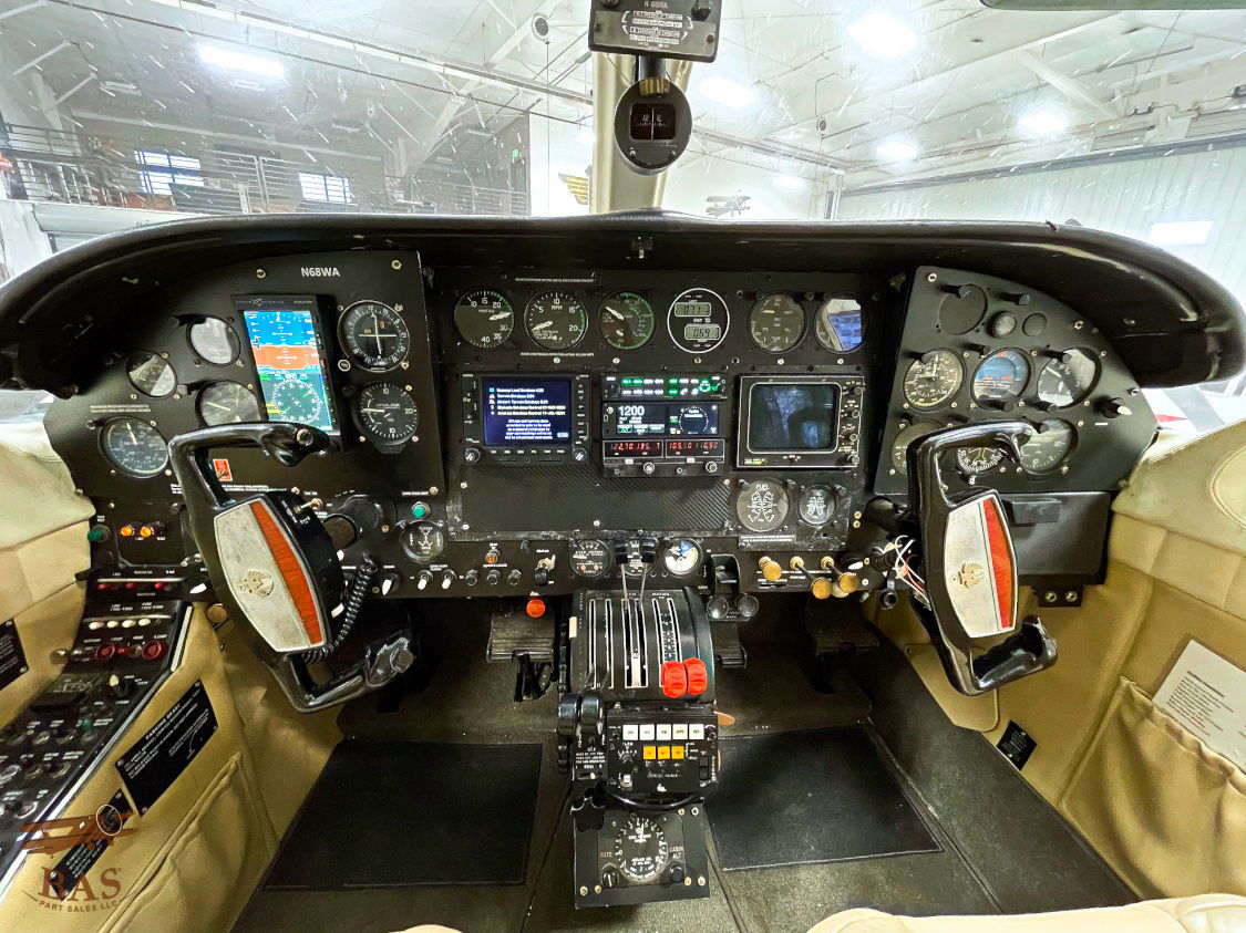 Interior view of an aircraft cockpit with various instruments and controls.