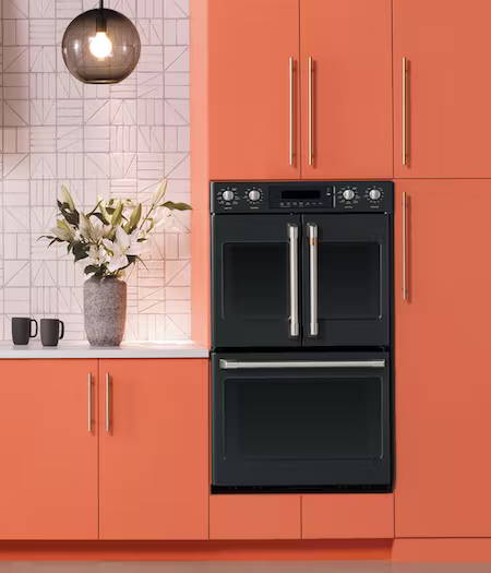 matte black wall oven in coral cabinets