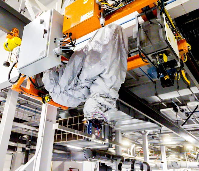 image of robotic palletizing arm on a crane