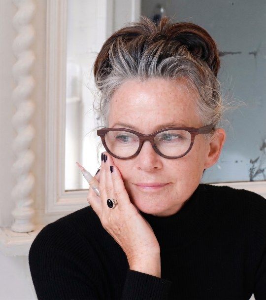Woman with grey hair wearing Charm Purple, dark cat eye glasses