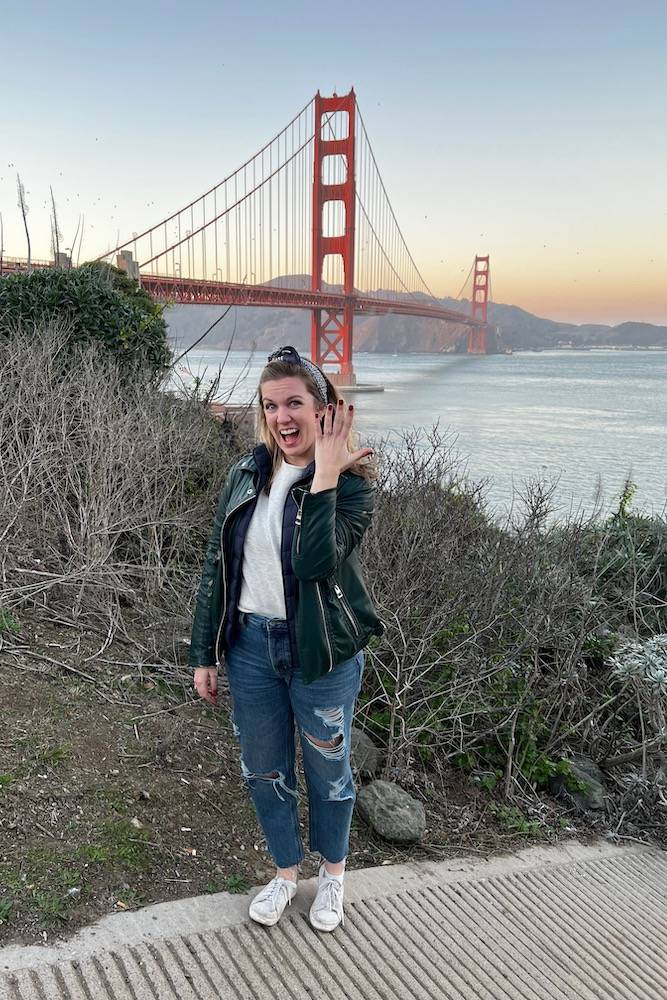 newly engagemed woman showing ring golden gate bridge