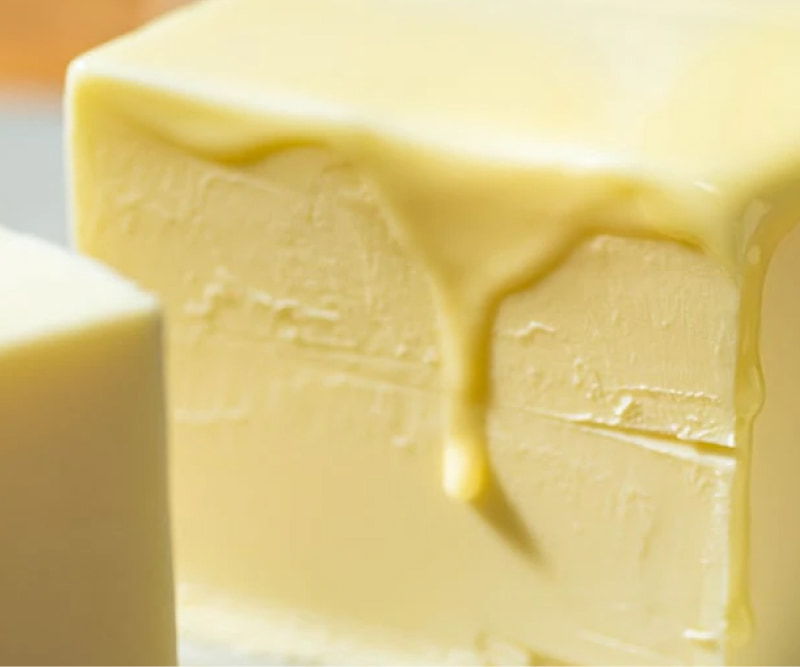 Close-up of creamy butter with a melting edge.