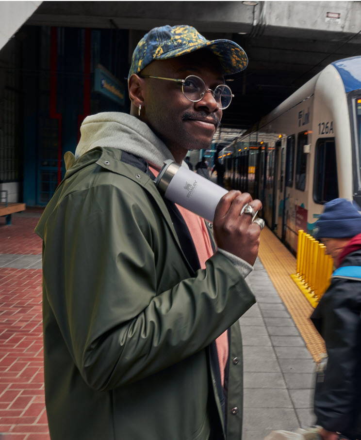 Man With An Aerolight Bottle Waiting For The Metro