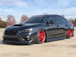 Front three-quarter dark grey Subaru WRX STI lowered stance red deep-dish wheels hood scoop front lip STANCE decal concrete lot Kristin's Shocker XL featured gallery photo 1
