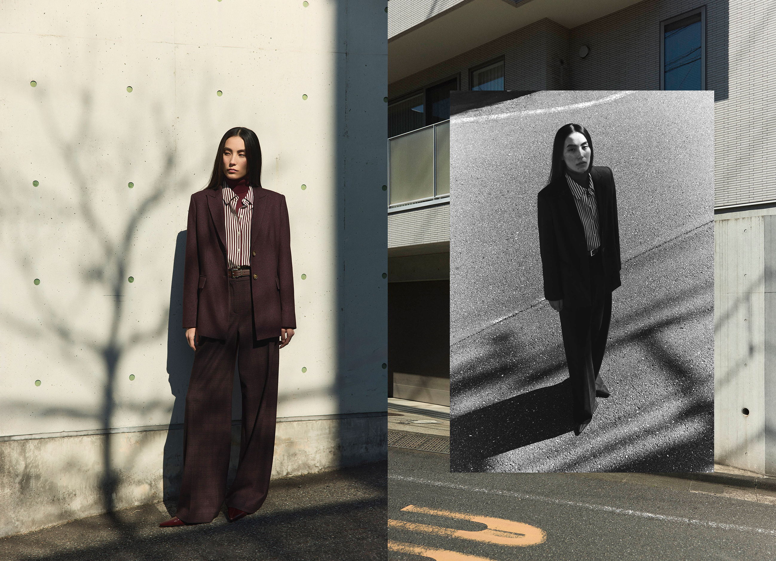 Model in dark attire standing against a textured wall and urban background.