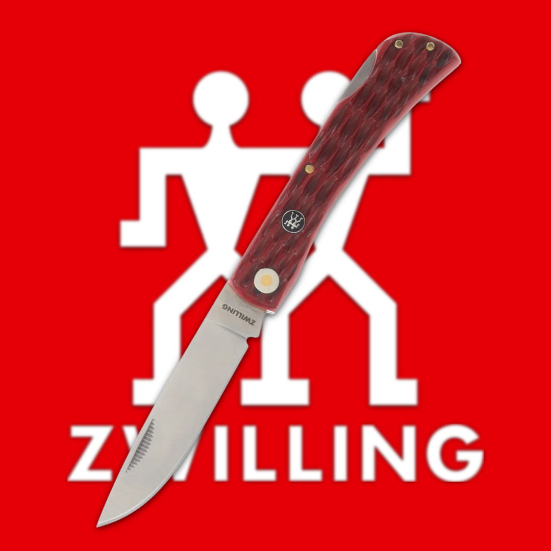 A folding knife in front of a red Zwilling logo.