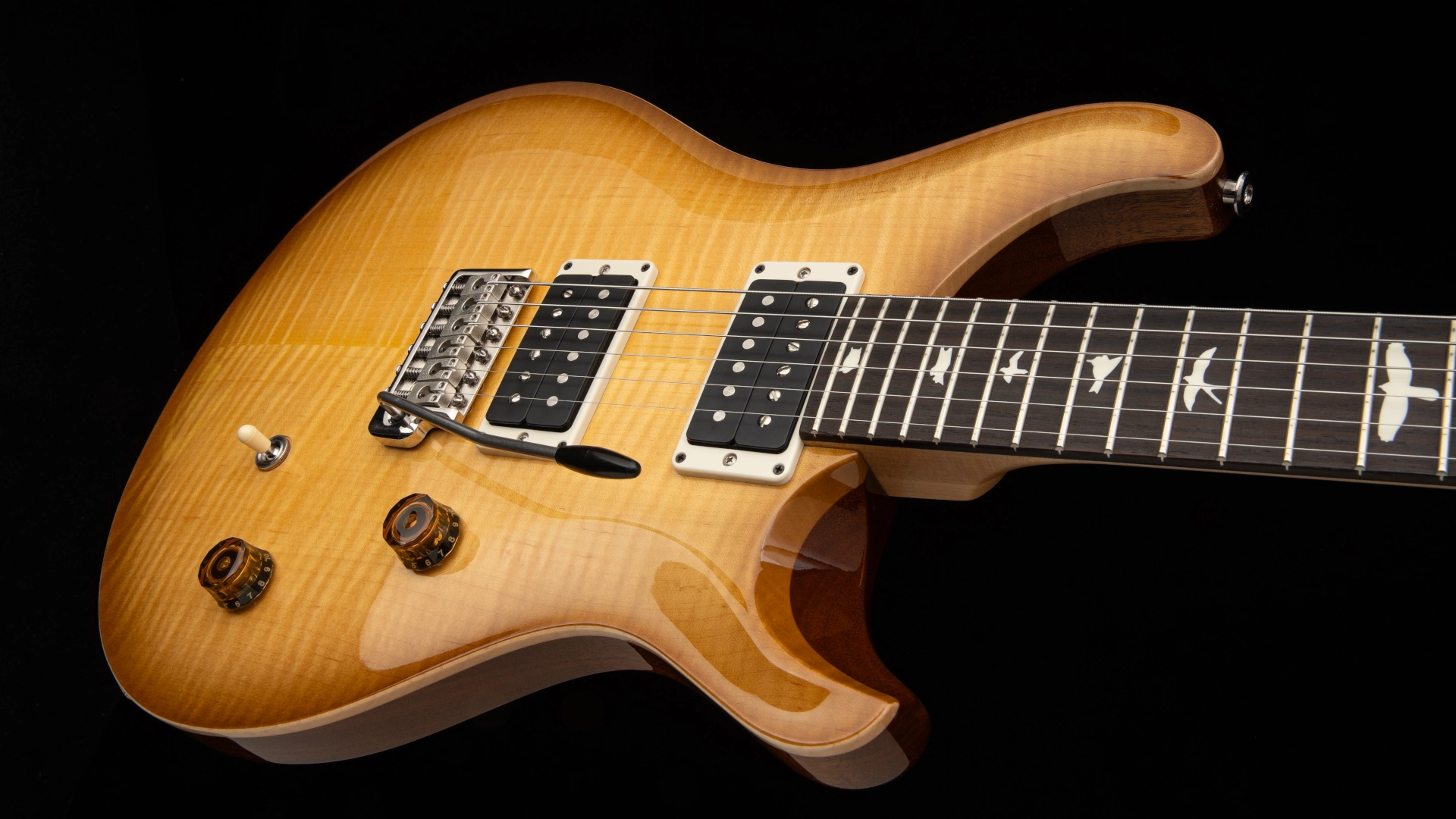 A close-up of a PRS CE 24 electric guitar with a glossy finish.