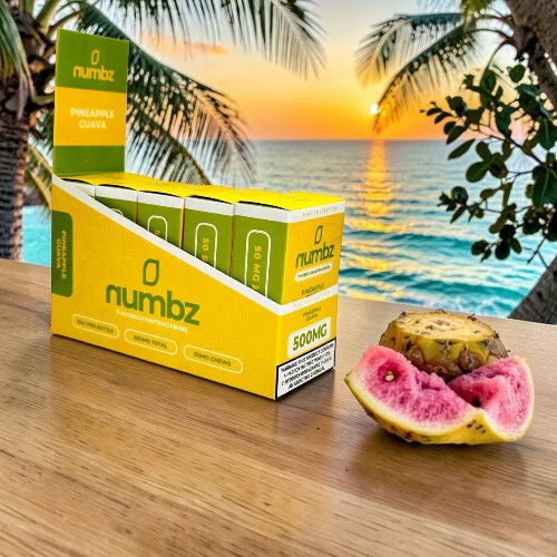 A box of Numbz next to a dragon fruit at sunset.