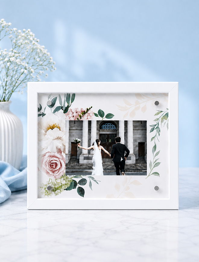 Wedding photo in a decorative frame with floral design.