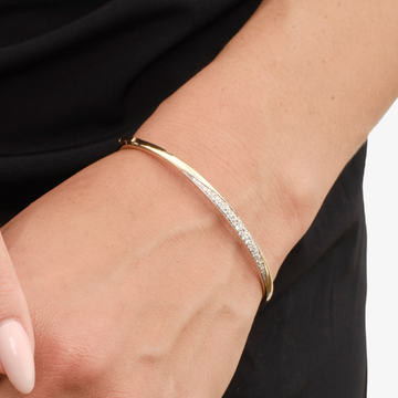 Gold and silver bangle bracelet with sparkling elements.